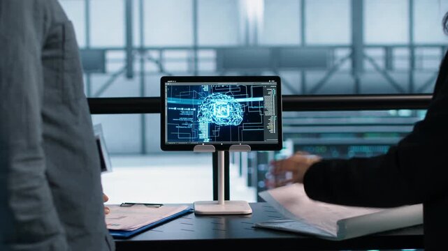 IT professionals use tablet in a server farm to apply artificial intelligence tools to server operations, combining documentation review, technical documentation and system diagnostics.