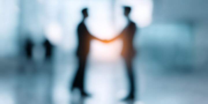 Blurred image of businesspeople shaking hands. Professional Business Agreement Concept
