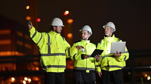 Construction workers team discussing project at night