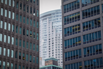 Naklejka premium Business skyscrapers and high rise office towers in downtown Toronto, Canada, dense corporate architecture, glass facades and the vertical skyline of the city's central business district in america.