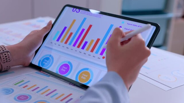 Tablet chart graph data analysis hand stylus report business digital dashboard colorful analytics screen finance planning office workspace reviewing document growth insights