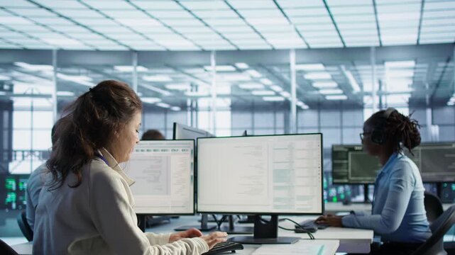 Data center manager overseeing server room holding impromptu meeting with employees from a secondary camera angle while highlighting data protection, network security and infrastructure risk.