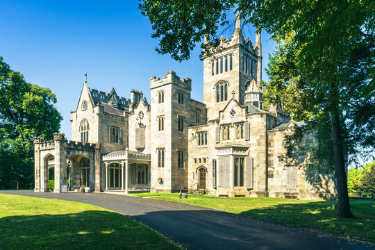 Tarrytown, NY- US - Jul 3, 2026 Sunlit view of Lyndhurst Mansion, a Gothic Revival estate in Tarrytown, New York, framed by lush trees and manicured grounds under a clear blue summer sky vibrant.