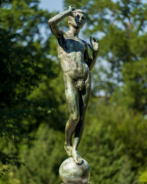 Tarrytown, NY- US - Jul 3, 2026 Standing atop a globe in the lush gardens of Lyndhurst Mansion, the bronze "Youth" sculpture by Sherry Edmundson Fry was a 1913 wedding gift to owner Helen Gould.