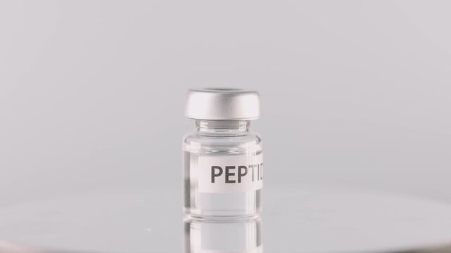 Clear glass vial bottle containing liquid medicine peptide therapy offers medical treatment option for vaccine research in clinical laboratory science aiming for health care improvement