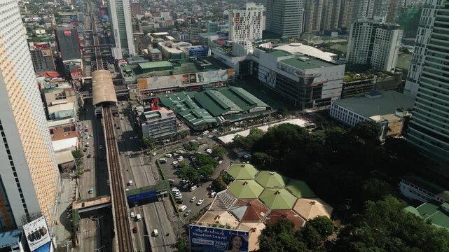 Aerial Dolly of Araneta City, Cubao, Metro Manila, featuring MRT train line, busy EDSA highway traffic, shopping malls, and corporate towers