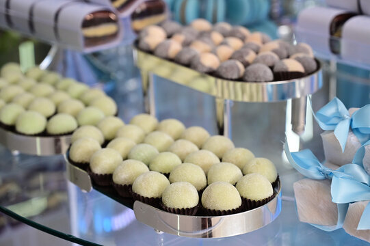 gourmet grape truffles on elegant celebration buffet, traditional brazilian wedding candy surpresa de uva, luxury dessert table catering presentation, sweet confectionery close up