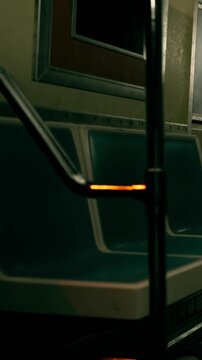Train interior features empty seats and a metal handle. The orange light adds a focus point. This scene captures the feeling of traveling late at night in the subway.