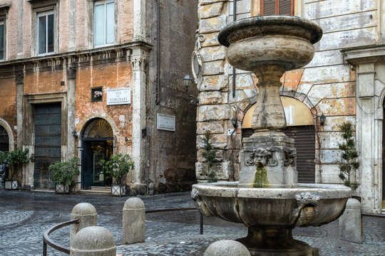 Old fountain on a small square in the historic center, Rome, Italy