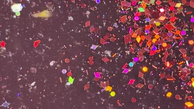 Colorful glitter particles closeup