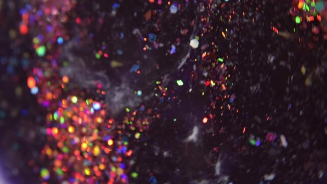 Colorful glitter particles background macro