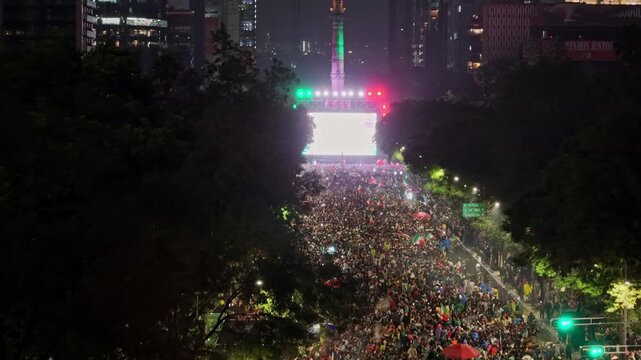 Aerial view of a crowd celebrating Mexico's World Cup victory, CDMX at night, Independence Monument, Mexico