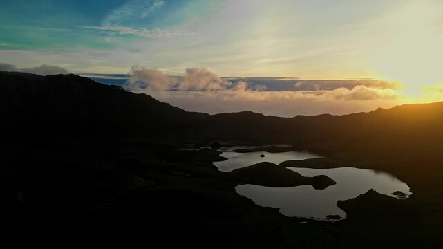 Dramatic sunset aerial view of the volcanic Corvo Crater lake and caldera at dusk, Corvo Island, Azores, Portugal