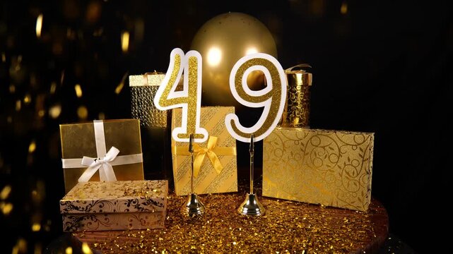 Gold Number 49 with Gold Glitter Confetti Sparkles with Gifts and Balloons for Party Forty Nine