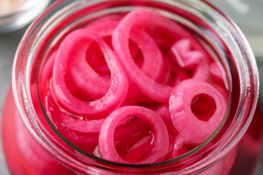 Homemade pickled red onion rings in a glass jar