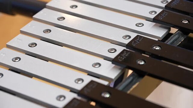 Close-up detail of xylophone bars with musical note markings