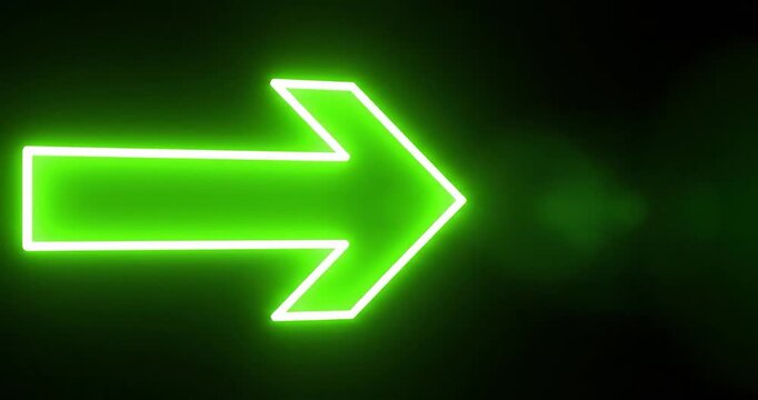 Bright neon green arrow sign glowing against a dark black background