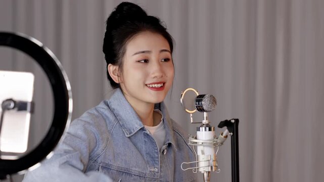 Artist musician practicing classical guitar, singing with microphone, live, acoustic performance in studio. Guitarist player woman string finger music fretboard play musical instrument for rock