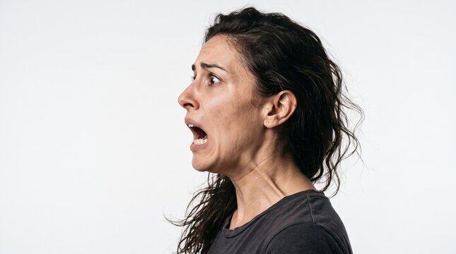 Woman screaming in fear with wide open mouth and terrified expression