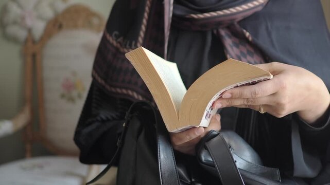 Exploring the pages of a cherished book in a cozy nook