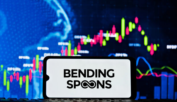 Bending Spoons Tech Company Logo Displayed on Smartphone with Stock Market Charts Background