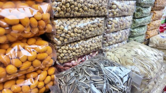 Assorted Nuts and Seeds Packaged in Plastic Bags at a Market