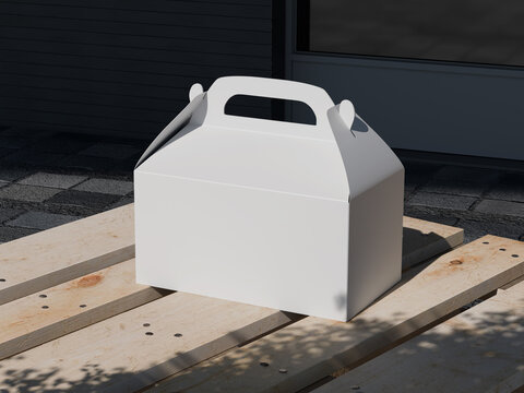 White gable box with handle on wooden surface outdoor mockup