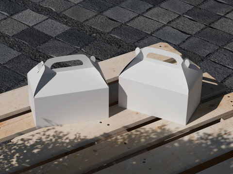 White gable boxes with handles mockup on wooden pallets outdoor for branding