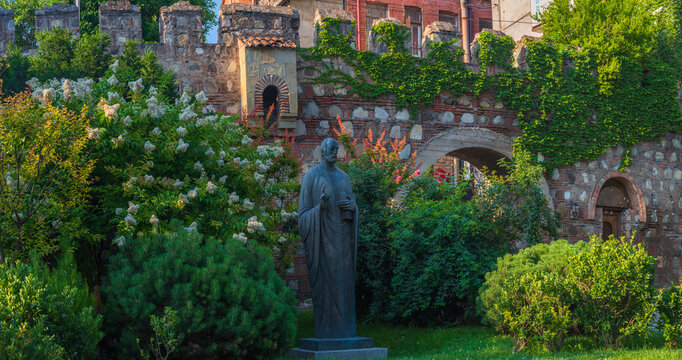 Monument near ancient Tbilisi city fortress wall covered in green ivy