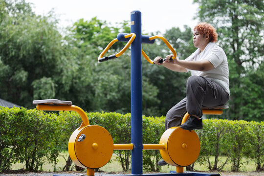 Determined Overweight Gen Z Teen Exercising at Outdoor Fitness Park &ndash; Weight Loss Journey and Healthy Lifestyle Concept
