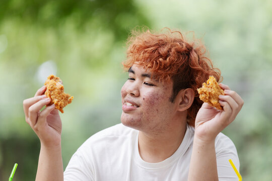 Gen Z Teen Enjoying Crispy Fried Chicken &ndash; Unhealthy Junk Food, Fast Food Addiction and Poor Nutrition Concept