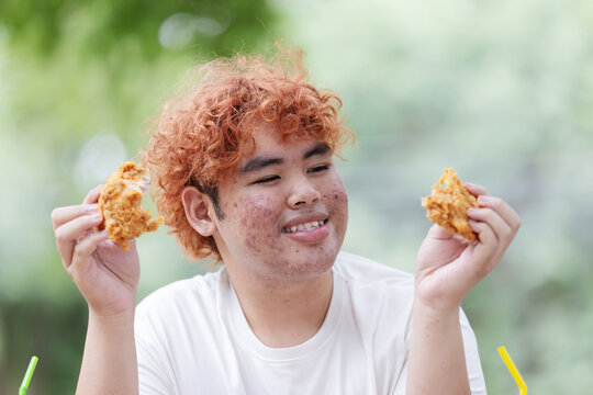 Gen Z Teen Enjoying Crispy Fried Chicken &ndash; Unhealthy Junk Food, Fast Food Addiction and Poor Nutrition Concept