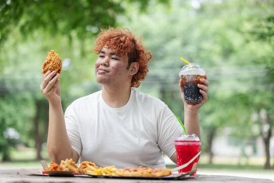 Happy Gen Z Teen Enjoying Fried Chicken and Soft Drink Outdoors &ndash; Fast Food Lifestyle, Youth Culture and Unhealthy Eating Habit