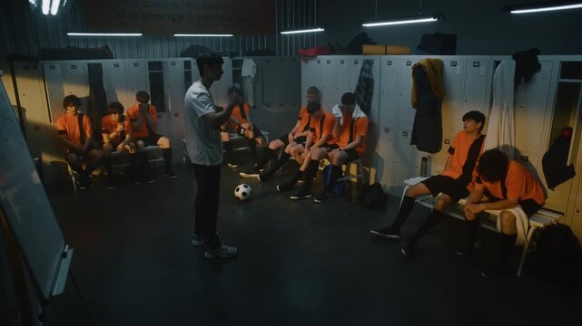 Coach Stands Before Group of Exhausted Teenage Football Players in Locker Room. Man Gestures, Expressing Disappointment and Critiquing Performance After Defeat. Mentorship and Youth Sports Discipline.