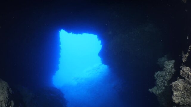 cave diving underwater scuba divers exploring caves and having fun ocean scenery sun beams and rays background