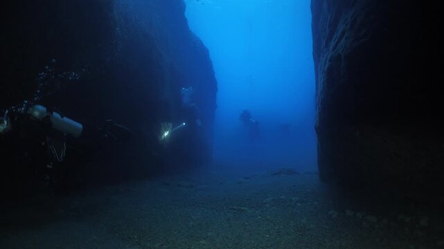 cave diving underwater scuba divers exploring caves and having fun ocean scenery sun beams and rays background