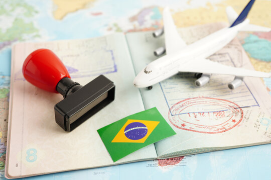 Brazil flag and passport with airplane for travel.