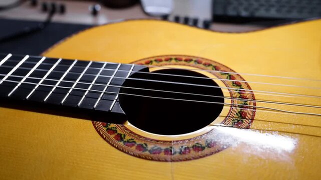 Classical guitar soundhole and strings vibrating after being plucked