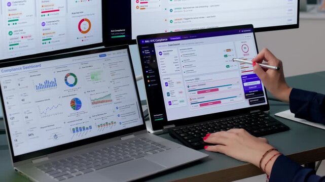 Compliance Officer Reviews Transaction Data On Laptop