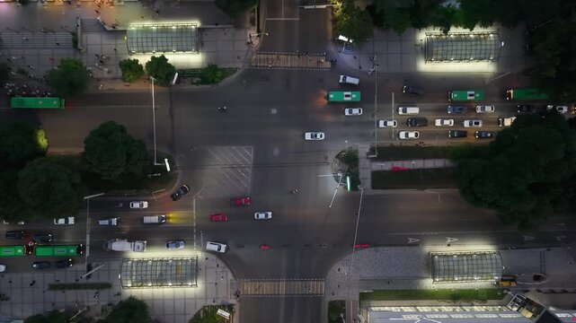 Aerial view of busy urban intersection with vehicles in motion at night