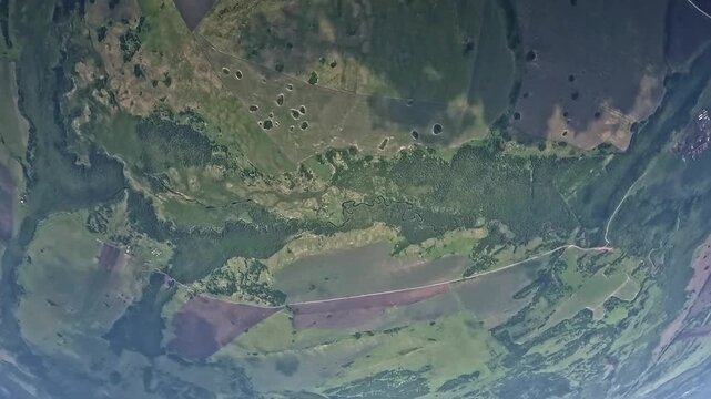 The parachutist falls out of the plane.  An action camera view from a high altitude on a clear day.
