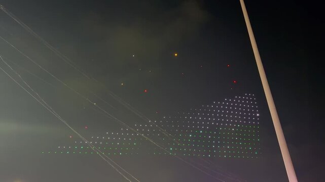 Glowing drone light show in Mahe forming a massive waving Seychelles national flag in the night sky during the 50th Independence Day anniversary.