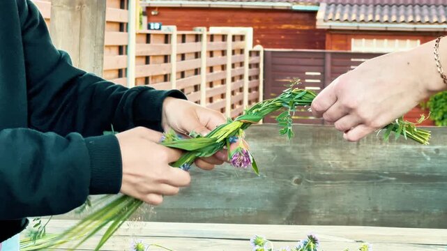A side view shows hands collaborating to weave a flower crown. Suitable for summer festival campaigns, team building workshops, craft blogs, and eco-branding.