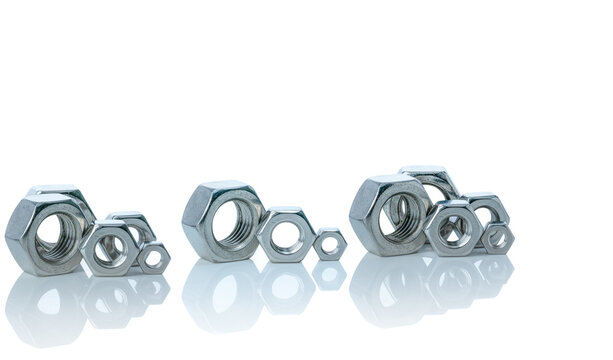 Set of metal hexagon nuts isolated on white background. Small, medium, and big of silver metal hexagon nuts. Hardware tool. Fastener with a threaded hole. Pattern of metal nuts with copy space.