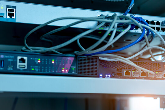 Ethernet cables and Network switch in data center. Wifi plug of internet router for computer. Network hub. Checkpoint equipment for data security. Communication networking wireless. Internet network.