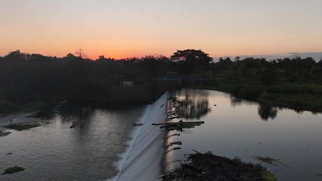 Sunset Dam Flyover. Water Hyacinth and Red Hues.