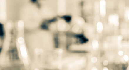 Fototapeta premium A blurred image of a laboratory setting with various glassware in the foreground. The focus is on the scientific environment, highlighting experimentation and research.