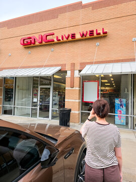 GNC Live Well store front with customer outside in Levisville, Texas