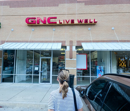 GNC Storefront with Signage in Levisville, TX, Showing Health Products