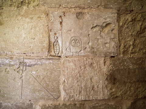 Drawings carved by prisoners on stone walls in Inquisitors Palace in historical part of Vittoriosa Birgu city in Malta.